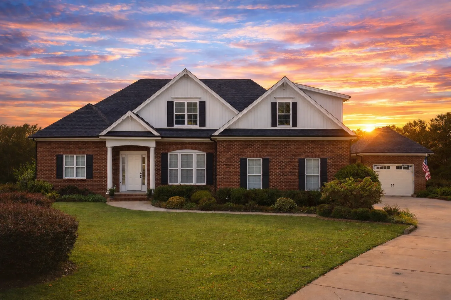 Front elevation of a New American Traditional style home with horizontal siding, gabled rooflines, shutters, and an attached garage