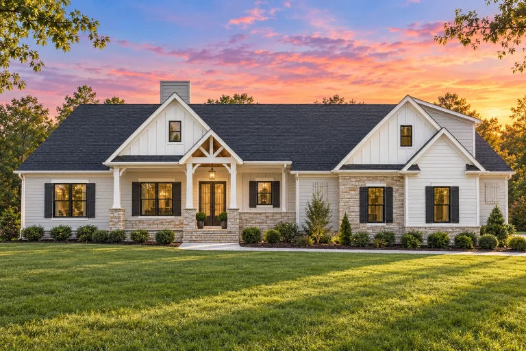 Southwestern House Plans 20 Front view of a Traditional Ranch style home featuring horizontal siding, stone porch columns, and a gable roof with an attached two-car garage