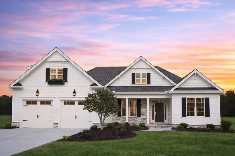 Front elevation of traditional ranch style home with horizontal lap siding, shake accents, gabled rooflines, and covered entry porch