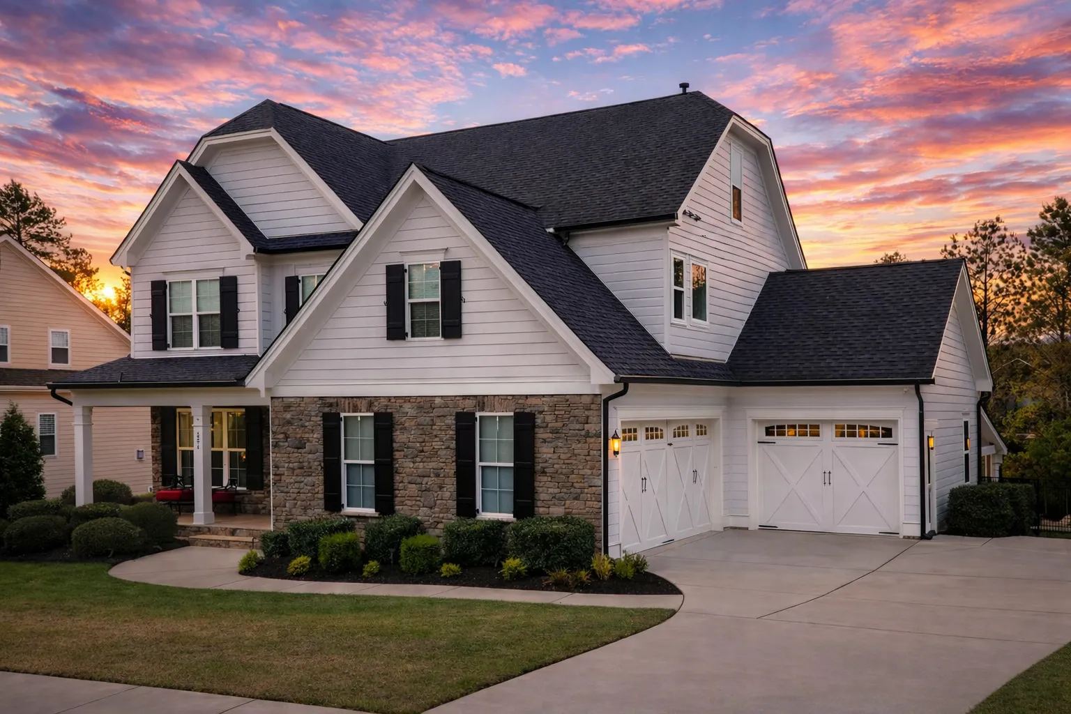 Front elevation of a New American Traditional house with horizontal siding, brick porch columns, symmetrical windows, and a welcoming covered entry
