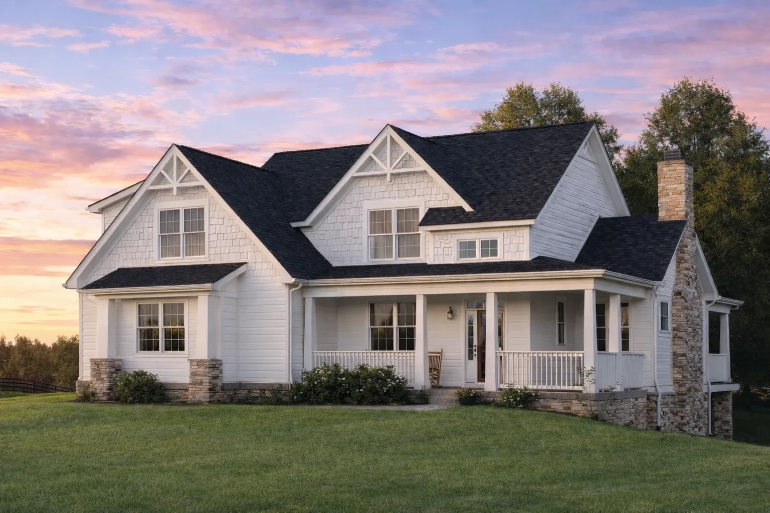 Front elevation of a Craftsman Traditional style home featuring stone and horizontal siding with gabled rooflines and a welcoming porch