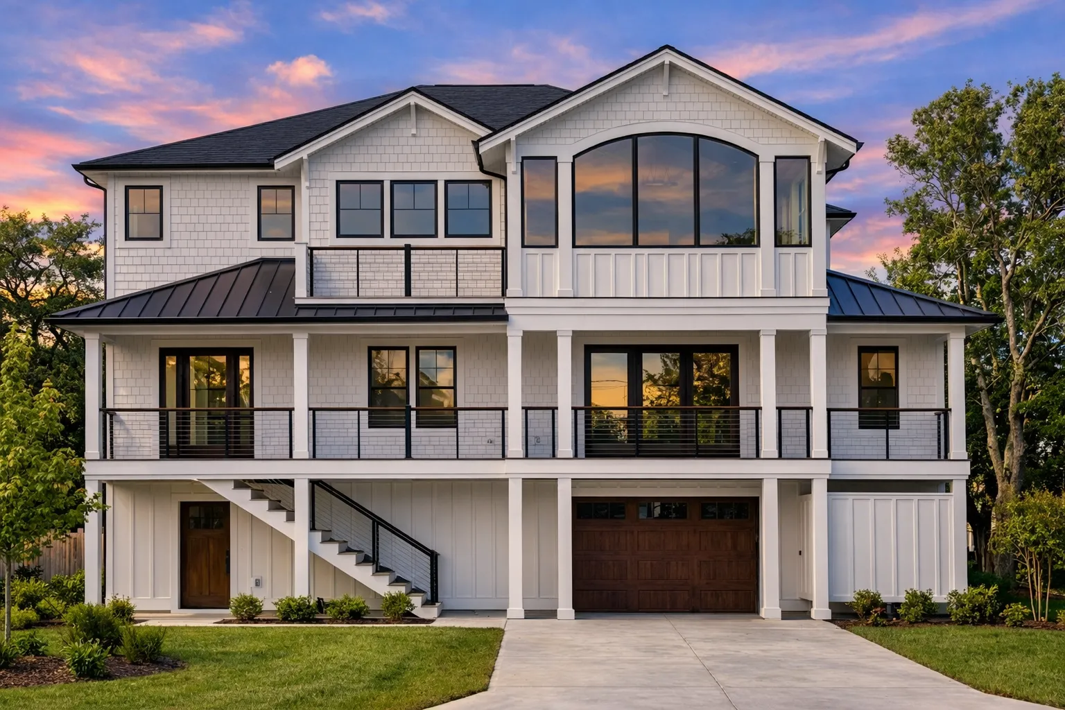 House Plans with Eating Bar 23 Front elevation of a Coastal Traditional house with horizontal siding, stone accents, symmetrical façade, covered balconies, and attached garage