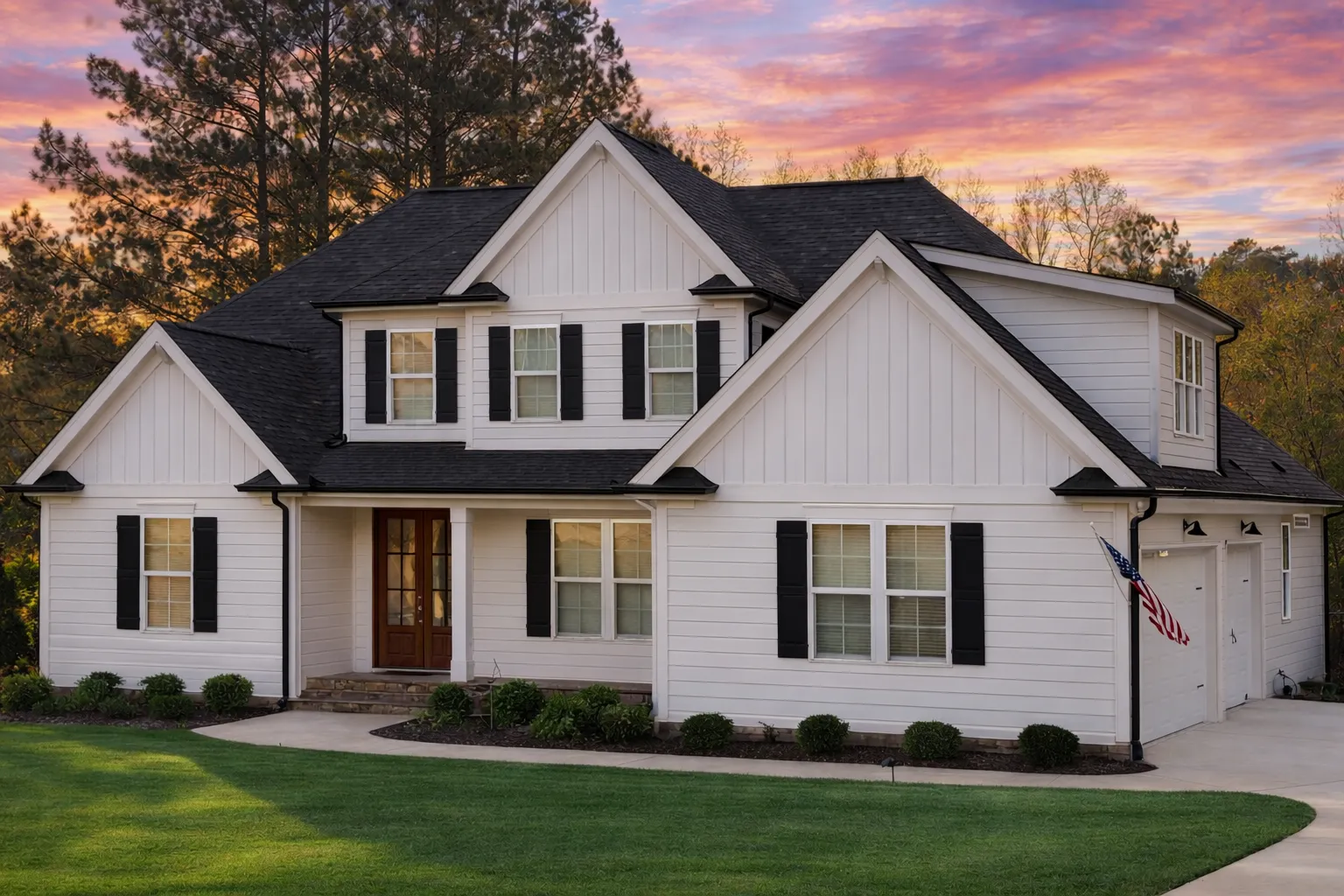 Front elevation of a Modern Farmhouse New American style home with board and batten siding, stone base, symmetrical windows, and covered porch