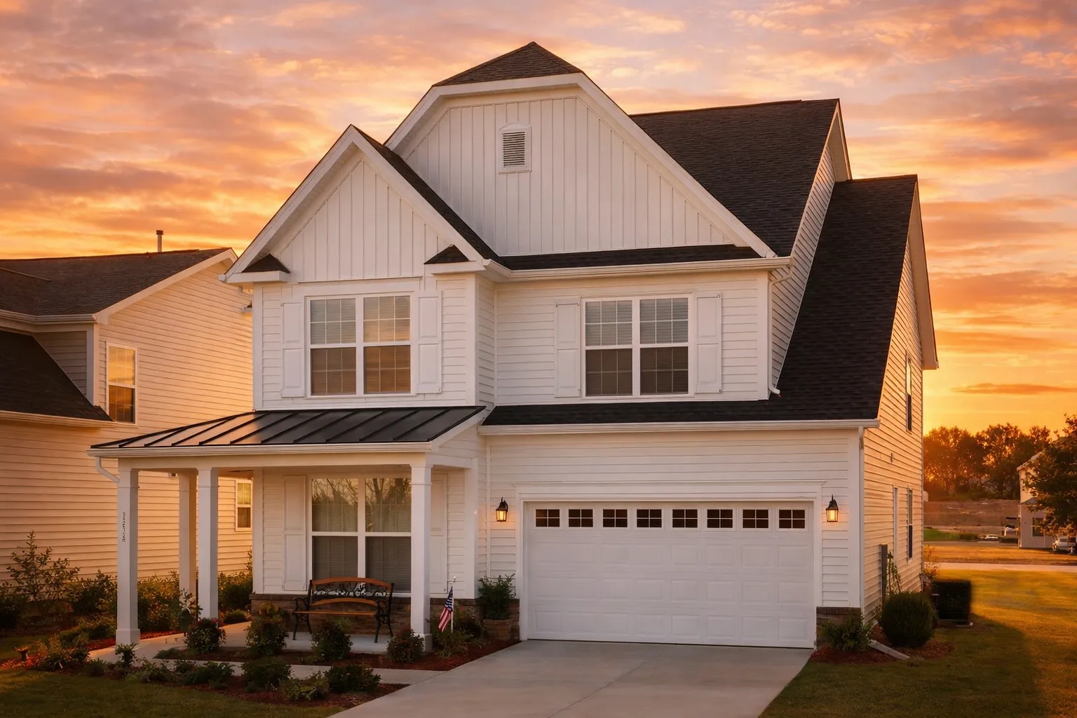 Front elevation of a Modern Farmhouse style home featuring board and batten siding, gabled rooflines, covered front porch, and attached two-car garage