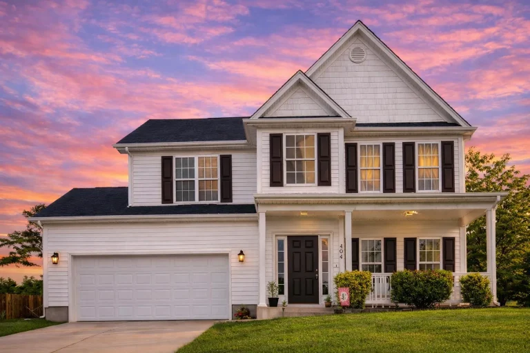 Transitional House Plans 22 Front elevation of a Traditional Colonial style home featuring light-toned horizontal siding, dark shutters, stone accents, and a symmetrical entry design.