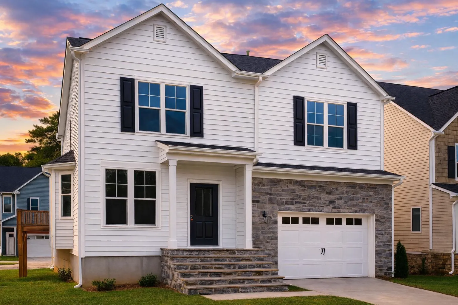 Front exterior of a New American style two-story house with horizontal siding, stone veneer, black shutters, and covered entry porch