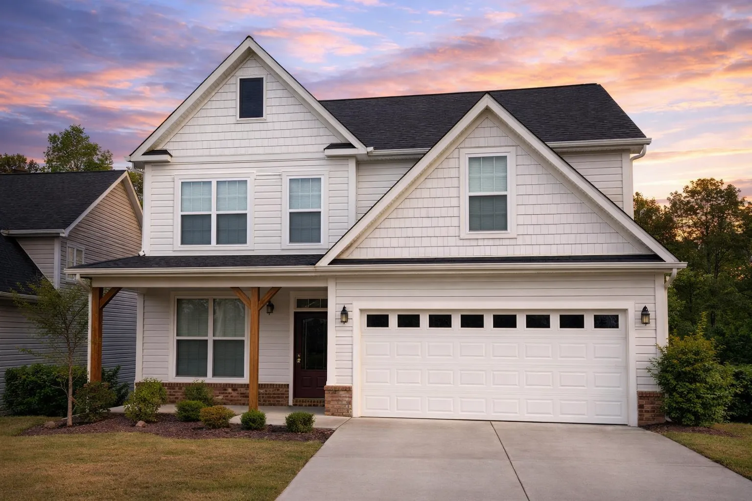 Front exterior view of a New American Modern Traditional house featuring horizontal siding, board and batten accents, stone veneer, and a covered front porch