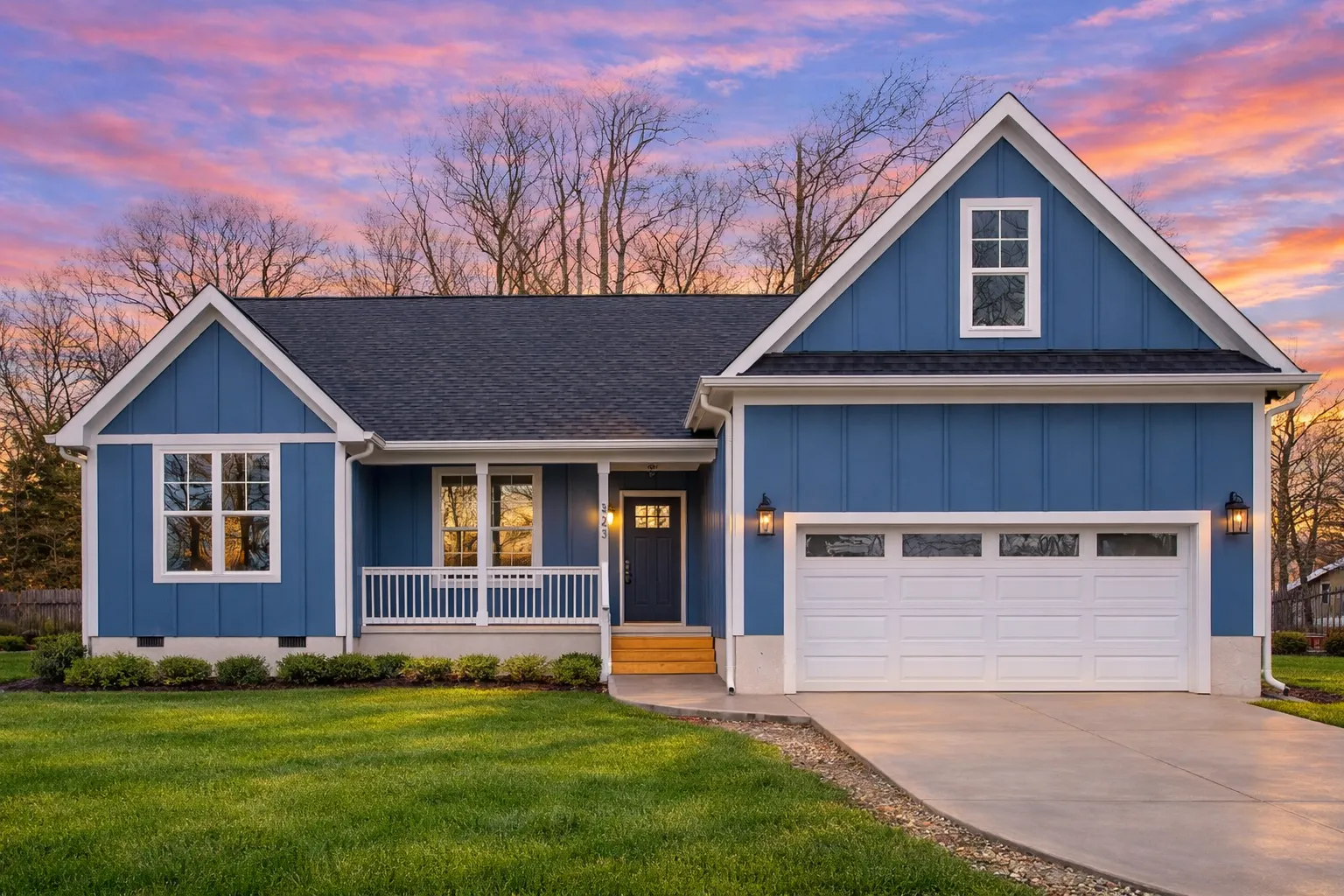 Front view of a Traditional Ranch and Craftsman Cottage style home with blue siding, board and batten accents, and inviting covered porch