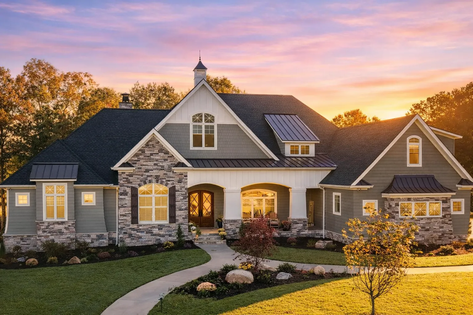 Front elevation of a New American style home with Traditional Craftsman details, stone accents, horizontal siding, and a welcoming covered porch