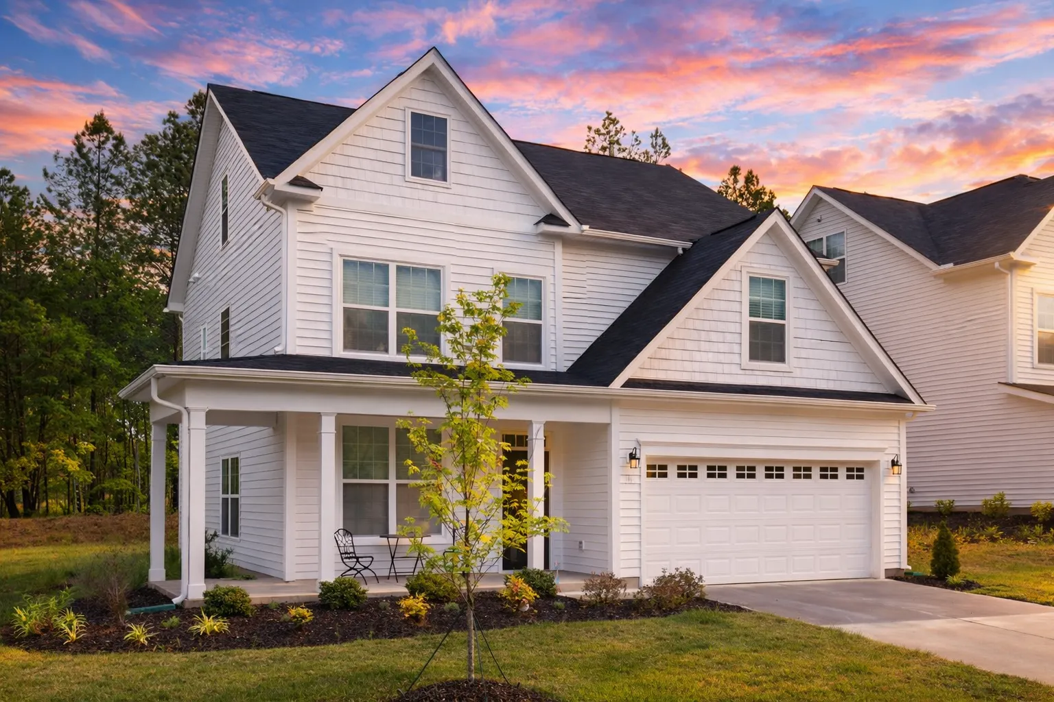 Modern Farmhouse home with white board-and-batten siding, black windows, and front porch