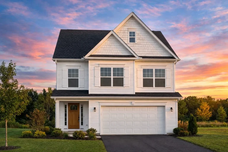 Front elevation of a Traditional New American style two-story house with light siding, gable rooflines, attached garage, and covered entry porch