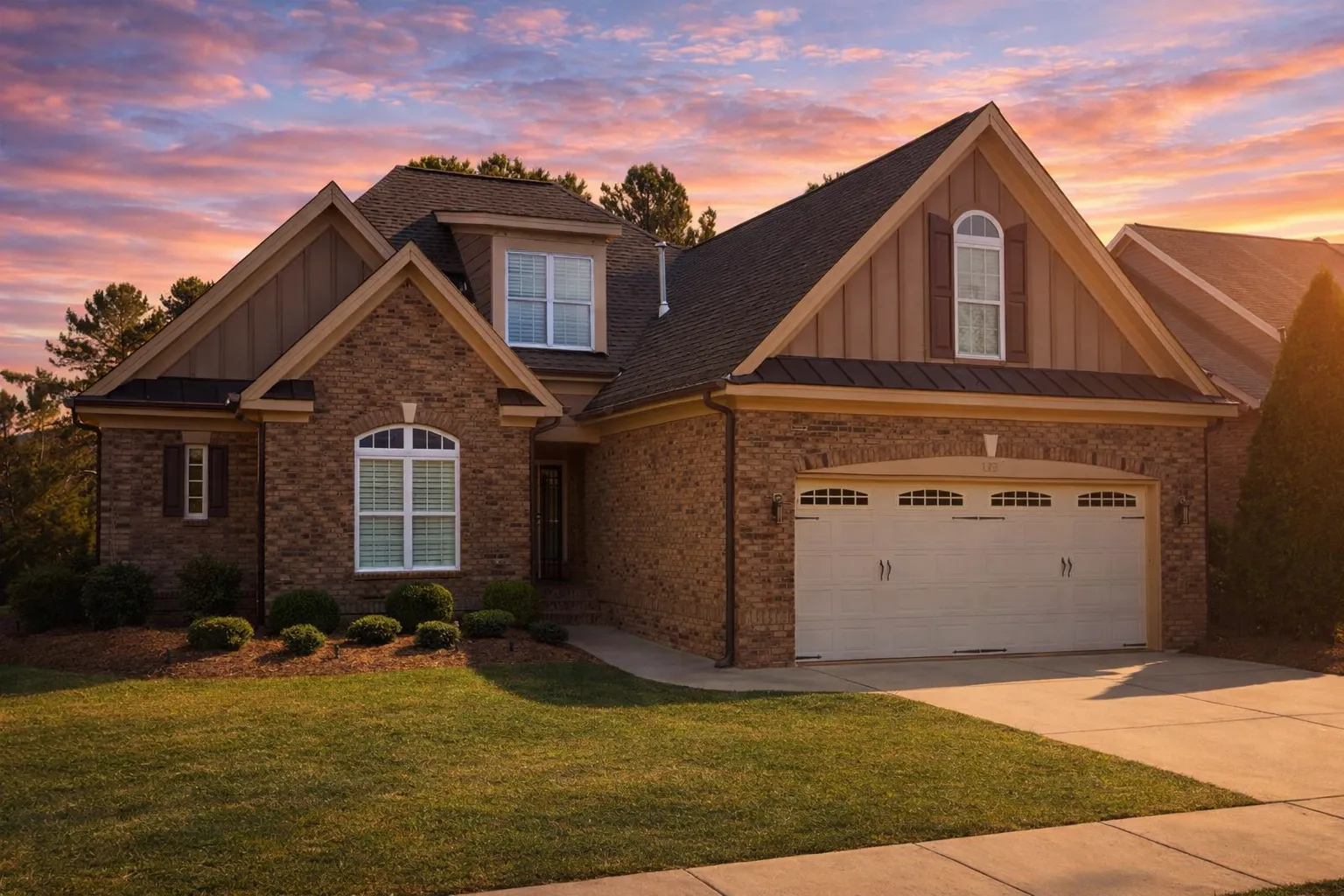 Narrow Lot House Plans 3 Front elevation of a New American Traditional style home featuring stone veneer, horizontal siding, gabled rooflines, and a front-entry garage