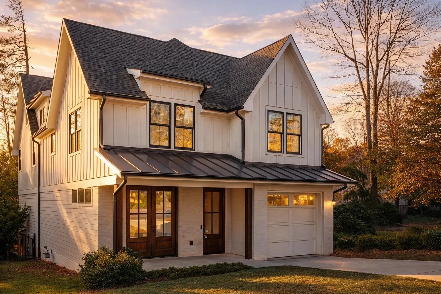 Front exterior view of a Modern Farmhouse New American style home featuring board and batten siding, gabled rooflines, and a covered entry porch