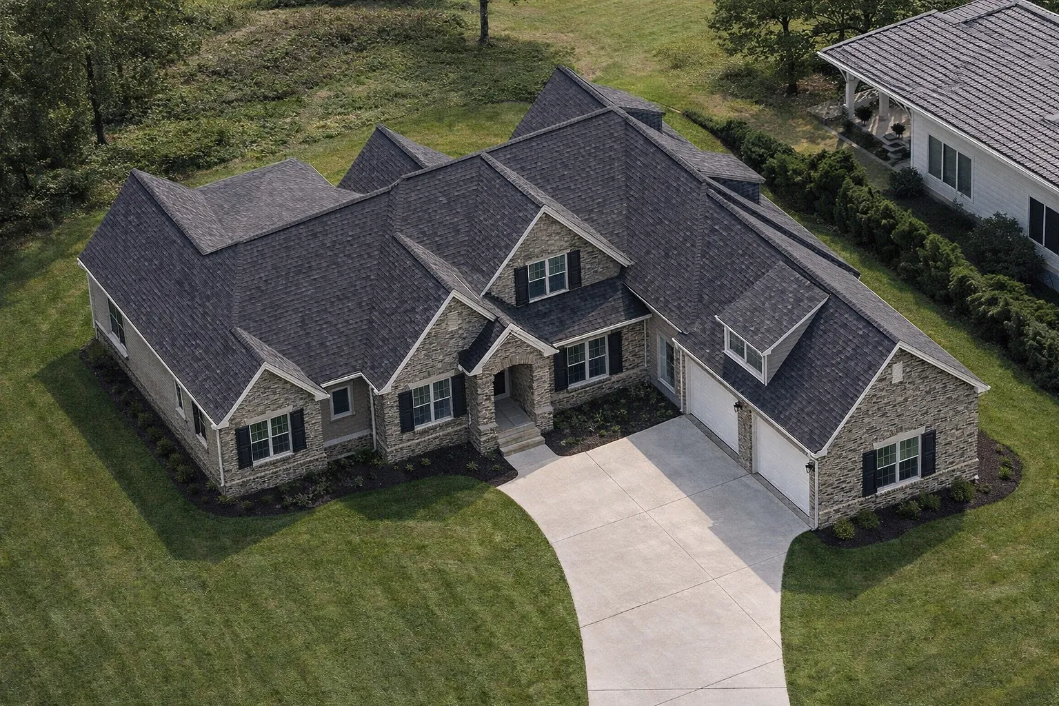 Front elevation of a Modern Farmhouse style home featuring board and batten siding, stone accents, dark shutters, and a welcoming covered entry