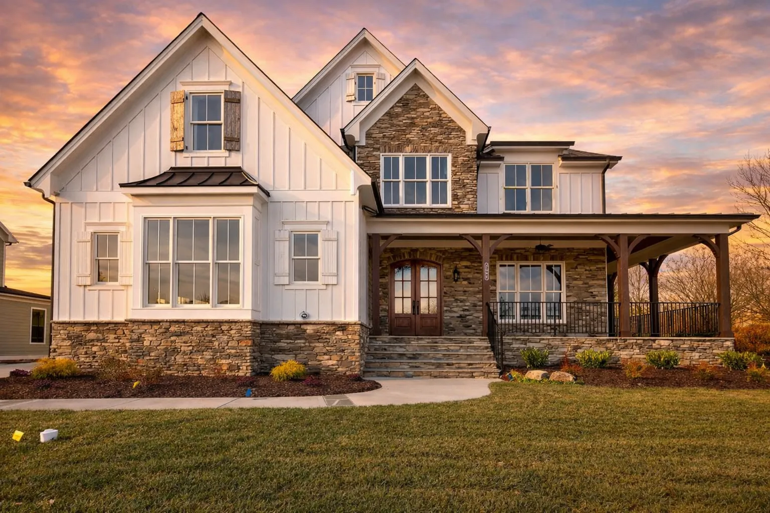 House Plans with Side-Load Garage 29 Front elevation of a New American Craftsman style home featuring stone veneer, board-and-batten siding, covered front porch, and classic suburban curb appeal