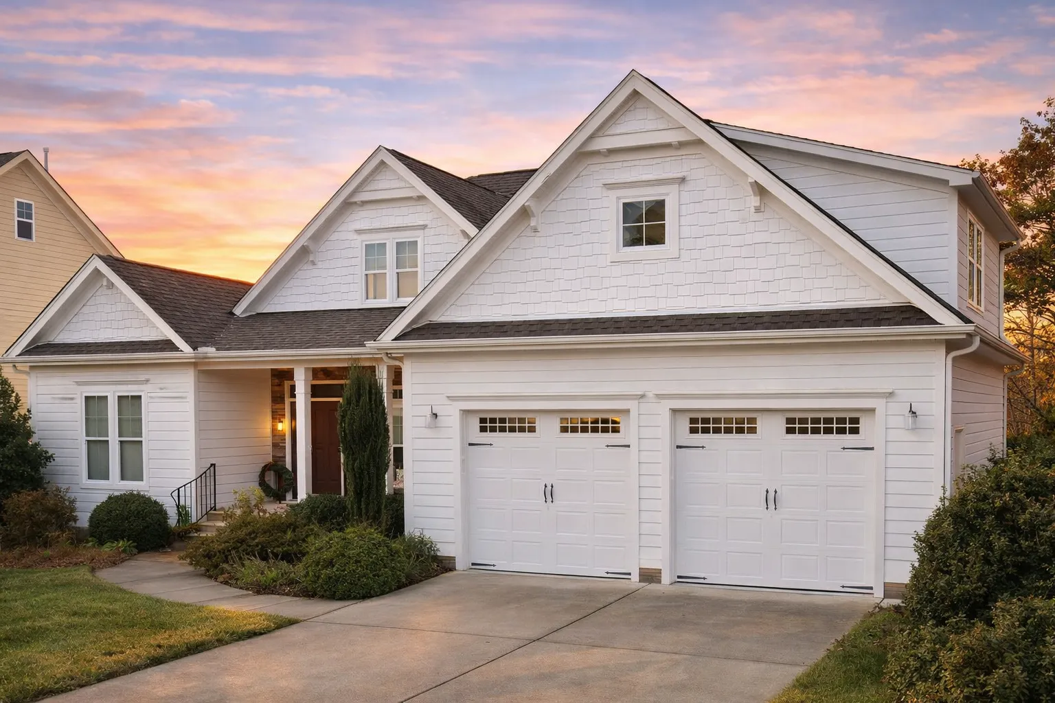 Craftsman ranch house with blue siding, front porch, and double garage