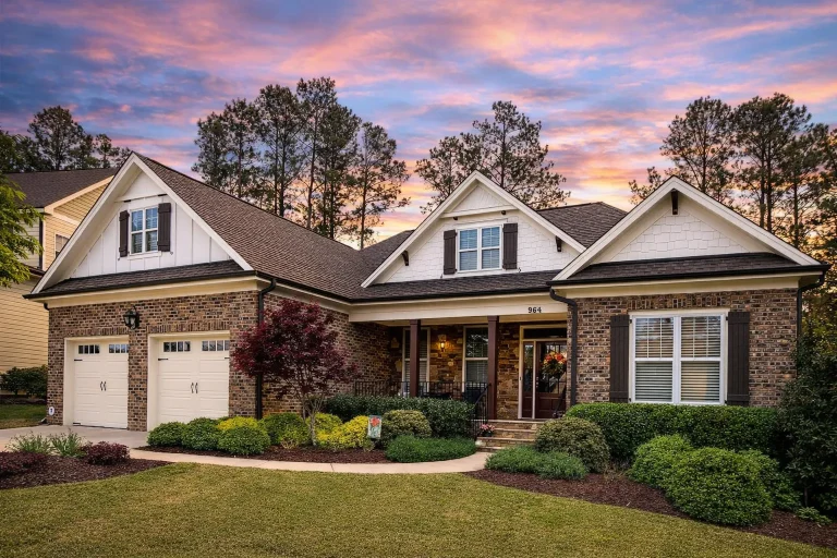 Front elevation of Traditional Craftsman home with brick and stone exterior, gabled rooflines, and covered entry porch