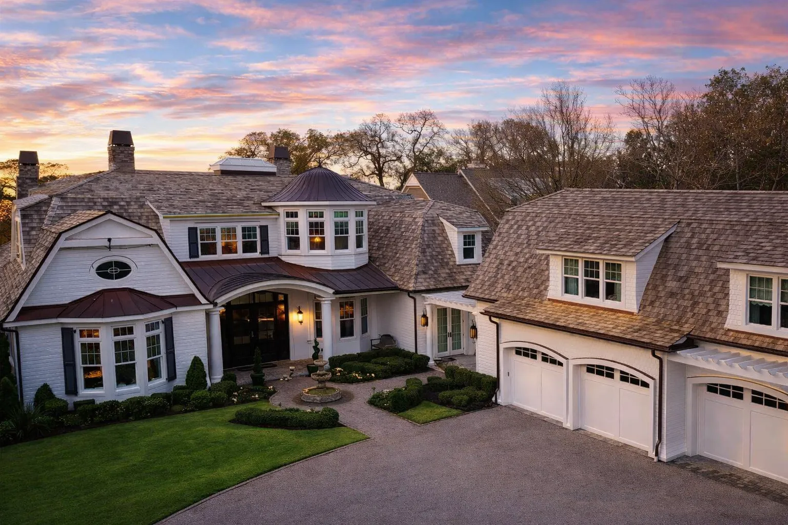 House Plans with Terrace 13 Front view of a Shingle Style Coastal home featuring classic shingle siding, natural wood roofing, arched dormers, white trim, and symmetrical architecture