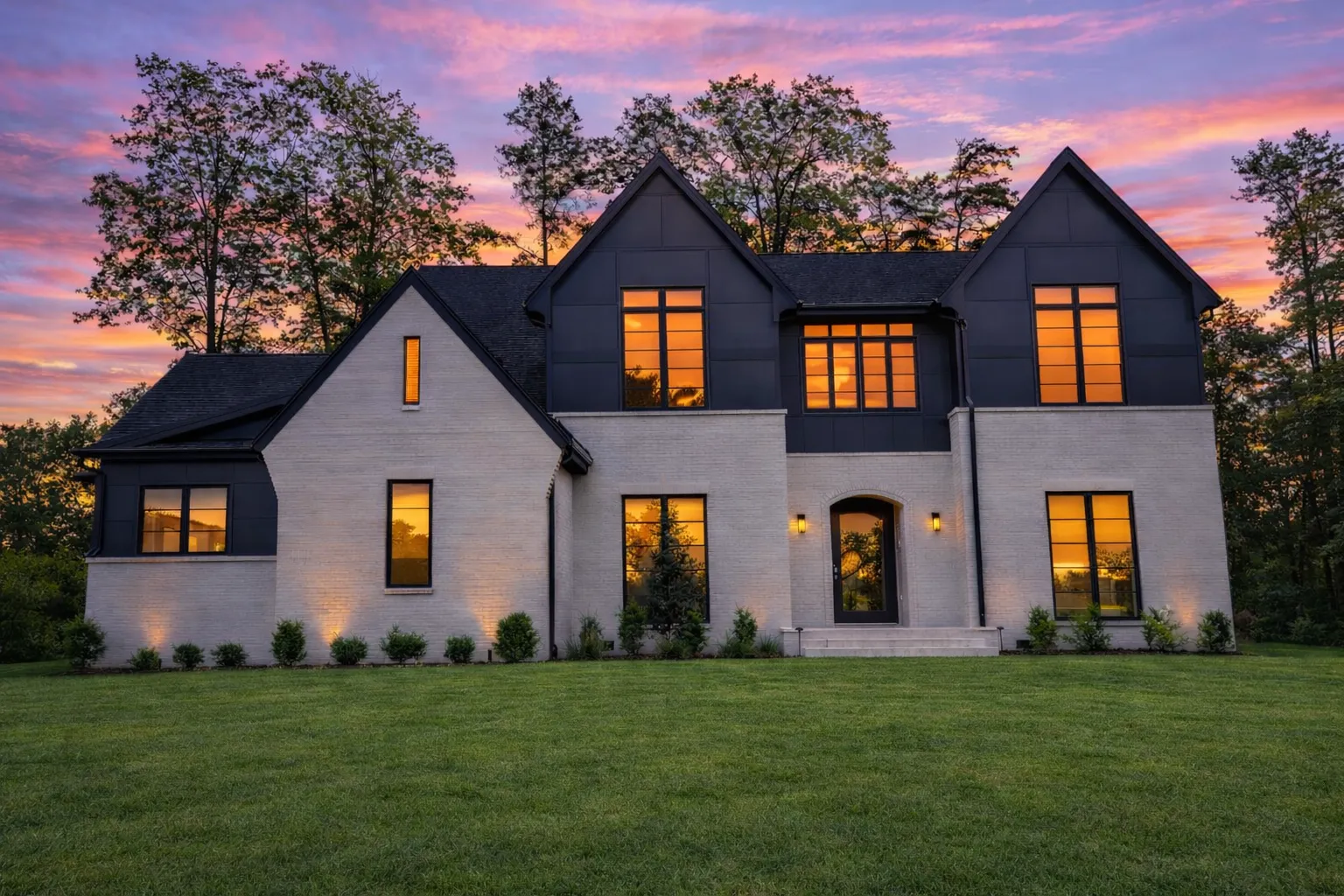 Front elevation of a New American Modern Traditional house featuring brick exterior, steep gabled rooflines, black windows, and symmetrical two-story design