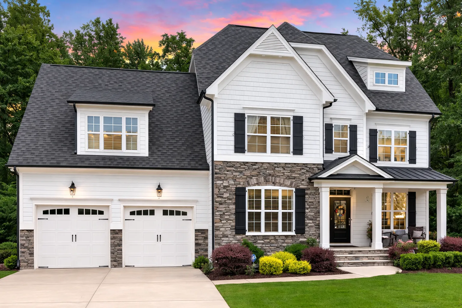 Front elevation of a New American Traditional Colonial style home featuring stone veneer, horizontal siding, symmetrical windows, and a covered front porch