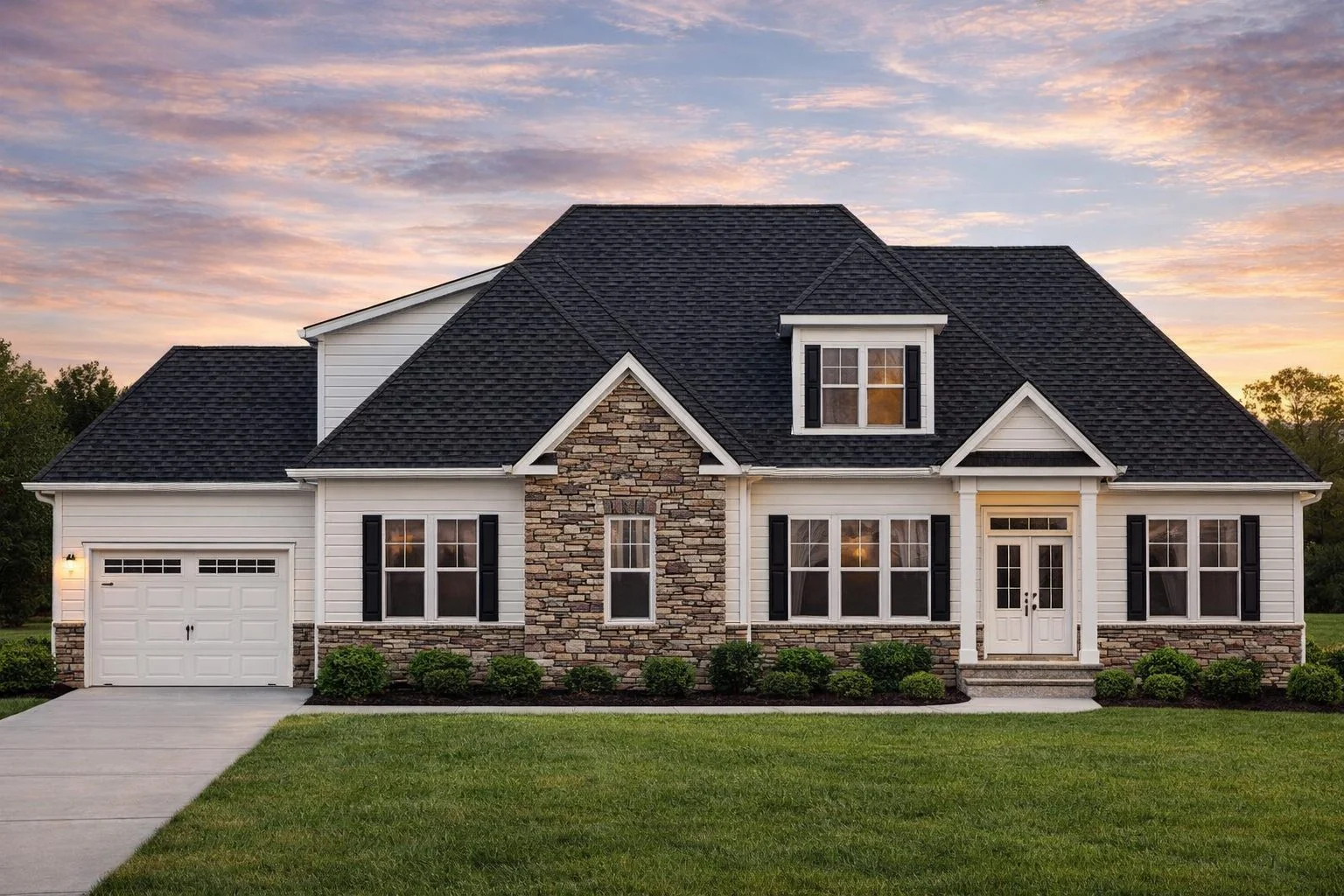 Front view of a Modern Farmhouse featuring stone and horizontal siding, gabled rooflines, and inviting front porch entryway