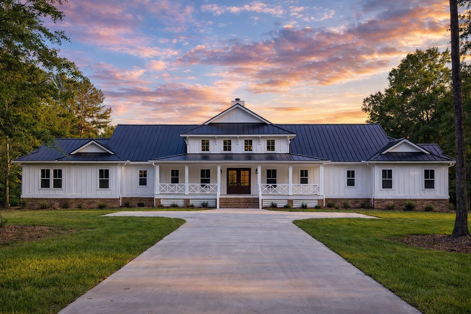 Front elevation of a Southern Farmhouse style home with horizontal siding, standing seam metal roof, symmetrical windows, and a covered front porch