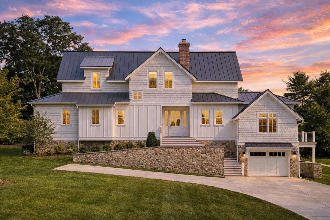 Front elevation of a New American modern traditional house with board and batten siding, stone foundation, metal roof, and side-entry garage