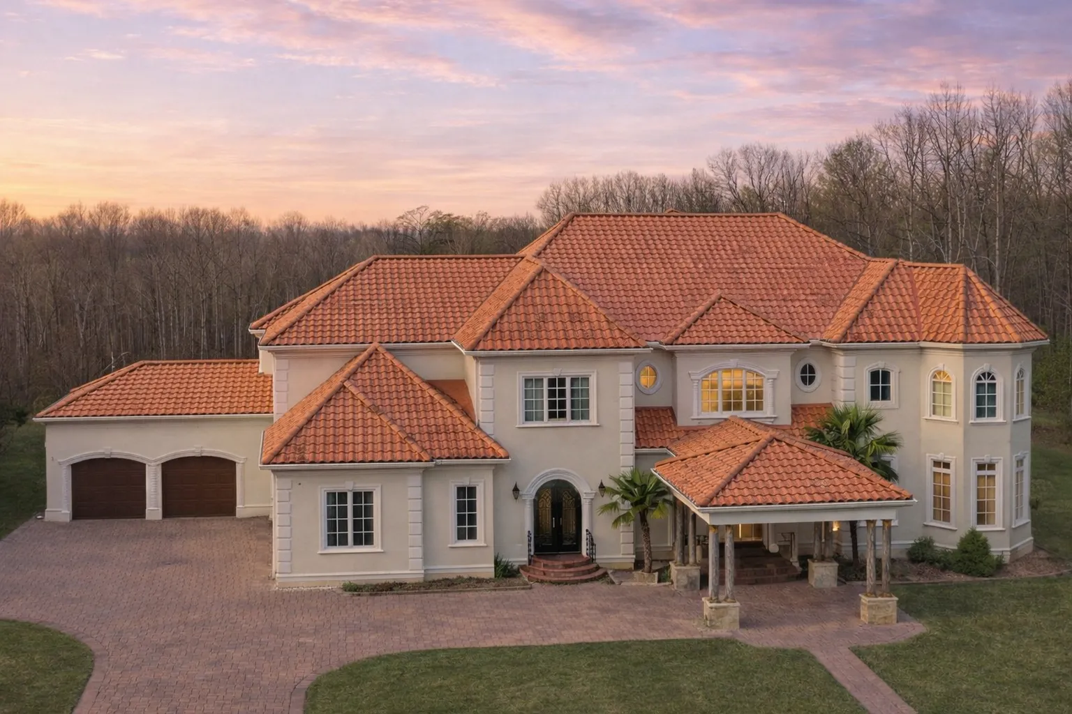 Front elevation of a French Provincial luxury home featuring full stone exterior, grand entry, symmetrical windows, and refined European architectural detailing