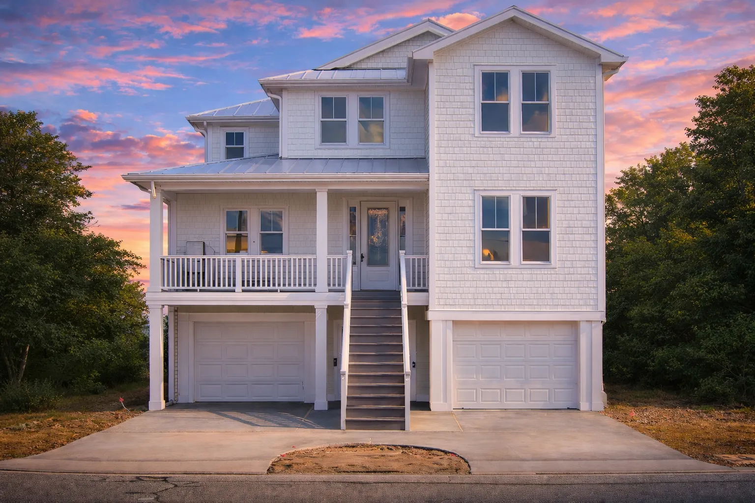Front elevation of a Coastal Traditional Charleston style house with white lap siding, raised brick base, double front porches, and symmetrical windows