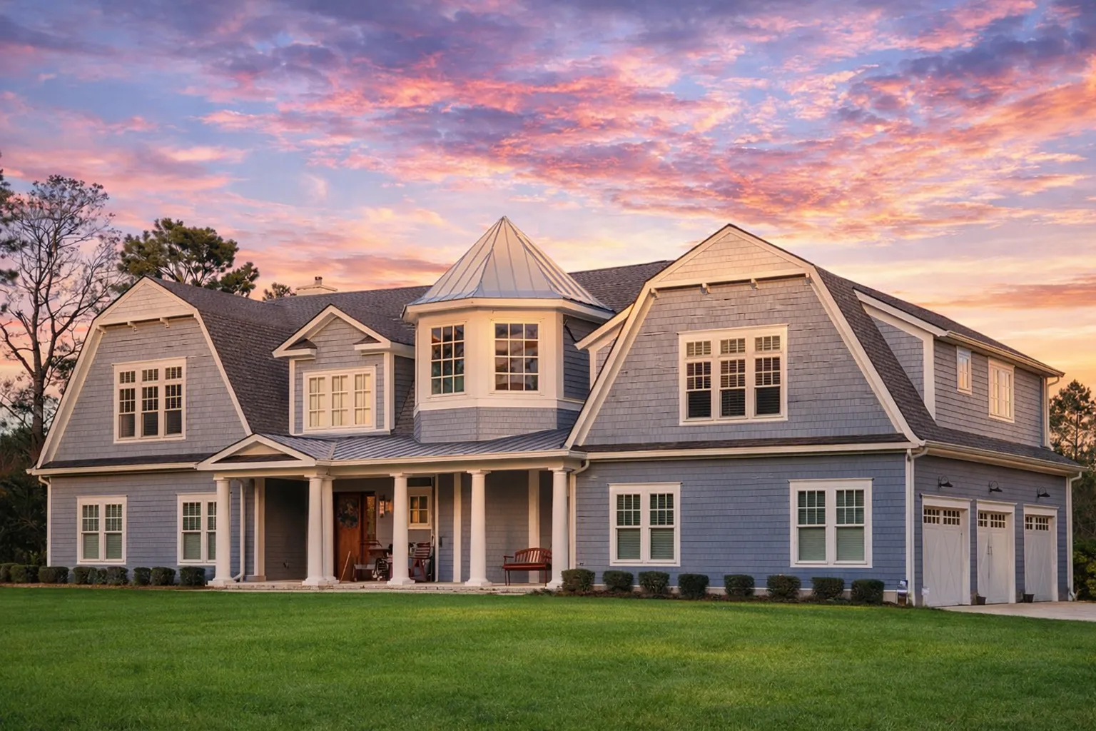 Front elevation of a Shingle Style New American house with shingle siding, symmetrical façade, dormer windows, covered front porch, and classic Colonial Revival detailing