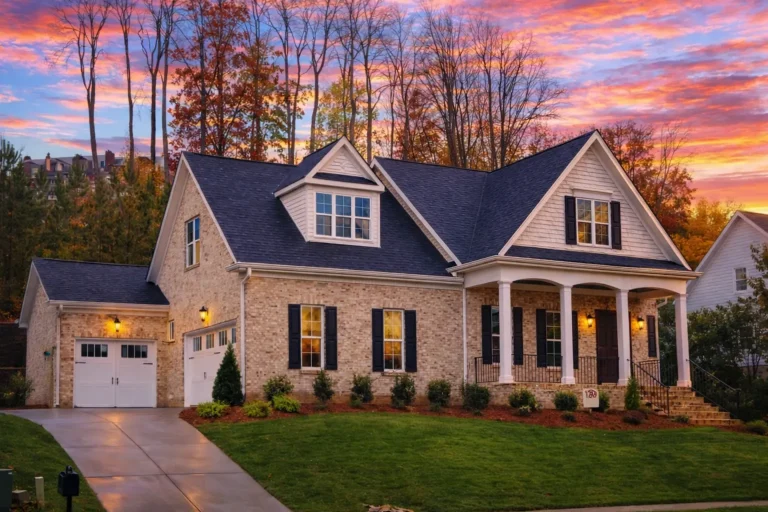 Front elevation of a New American modern traditional house featuring board and batten siding, stone accents, gabled rooflines, and an inviting arched entry