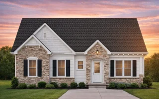 Front view of a Cottage style home featuring stone and horizontal siding exterior with black shutters and a welcoming entryway
