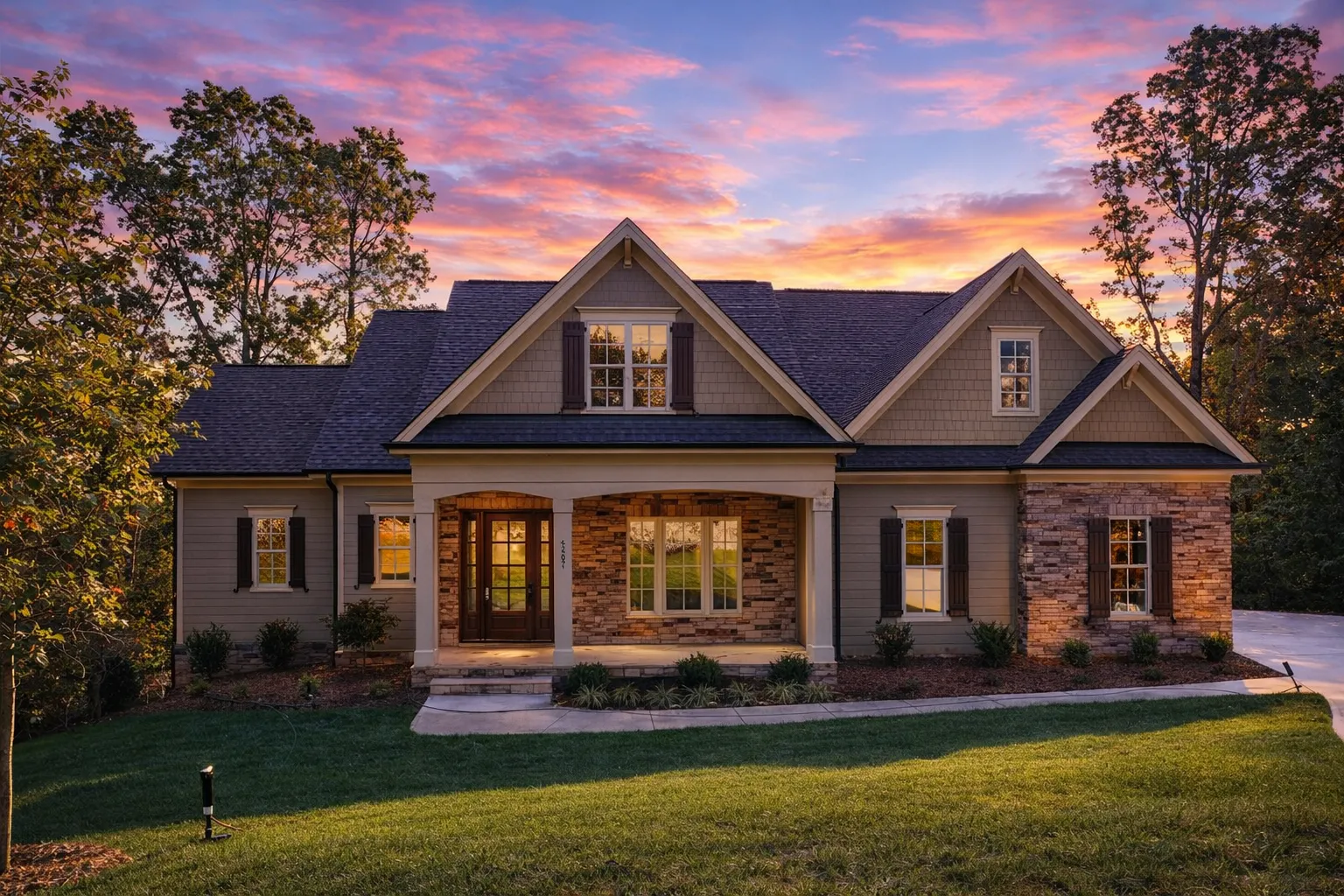 House Plans with Functional Layout 21 Front elevation of a New American Traditional style house featuring horizontal siding, stone accents, gabled rooflines, and an attached garage