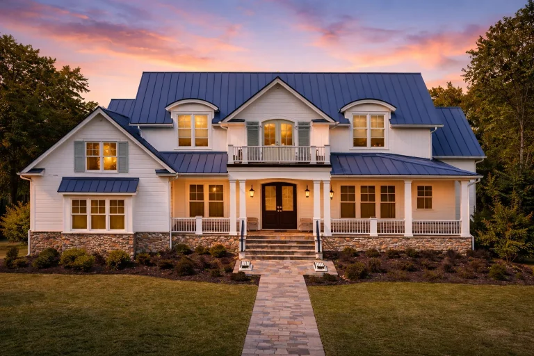Front elevation of a Traditional Colonial and New American style home featuring horizontal siding, stone accents, and a symmetrical façade