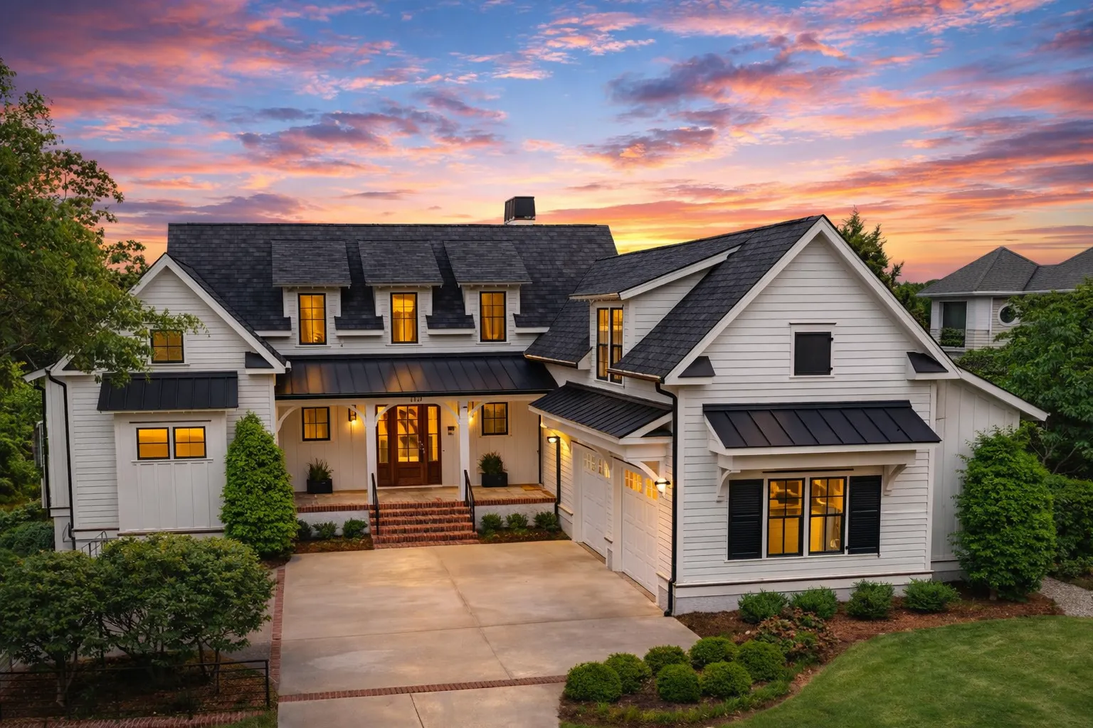 Front elevation of a Cape Cod style home with horizontal siding, stone foundation, dormer windows, and covered front porch