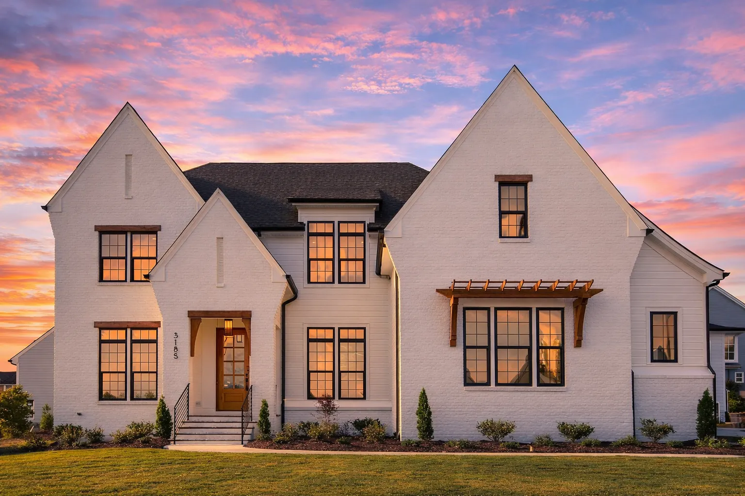 House Plans with Second Floor Laundry Room 1 Front elevation of a Modern Farmhouse style home featuring white stucco exterior, board and batten accents, steep gabled rooflines, and black-framed windows