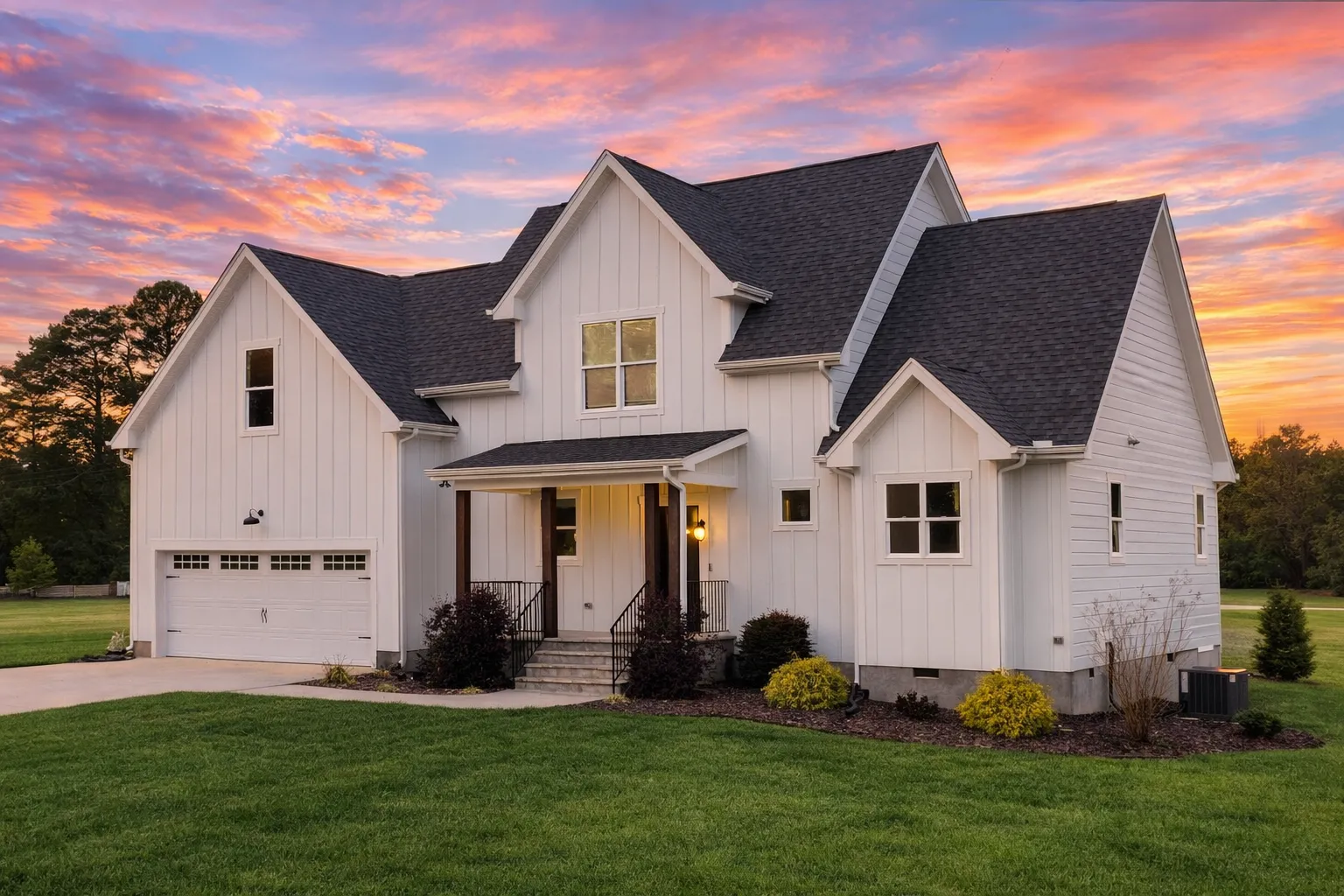House Plans 9 Front view of a Modern Farmhouse featuring board and batten siding, covered porch, and front-entry garage design.