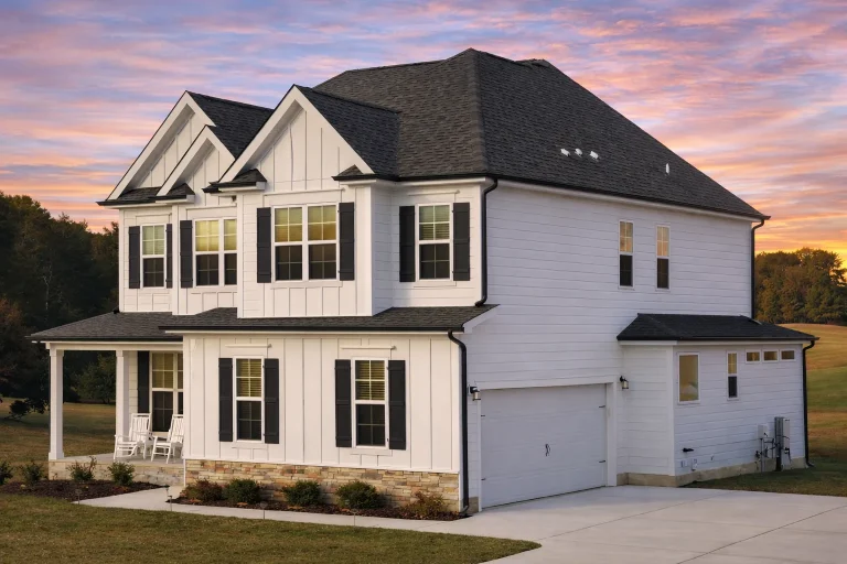 Front elevation of a New American modern traditional style home with horizontal siding, board and batten details, covered porch, and symmetrical windows