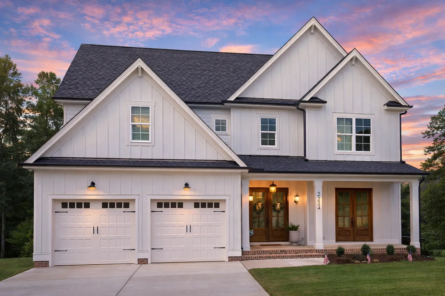 Front exterior view of a New American modern traditional house featuring mixed siding, double garage, and covered front porch