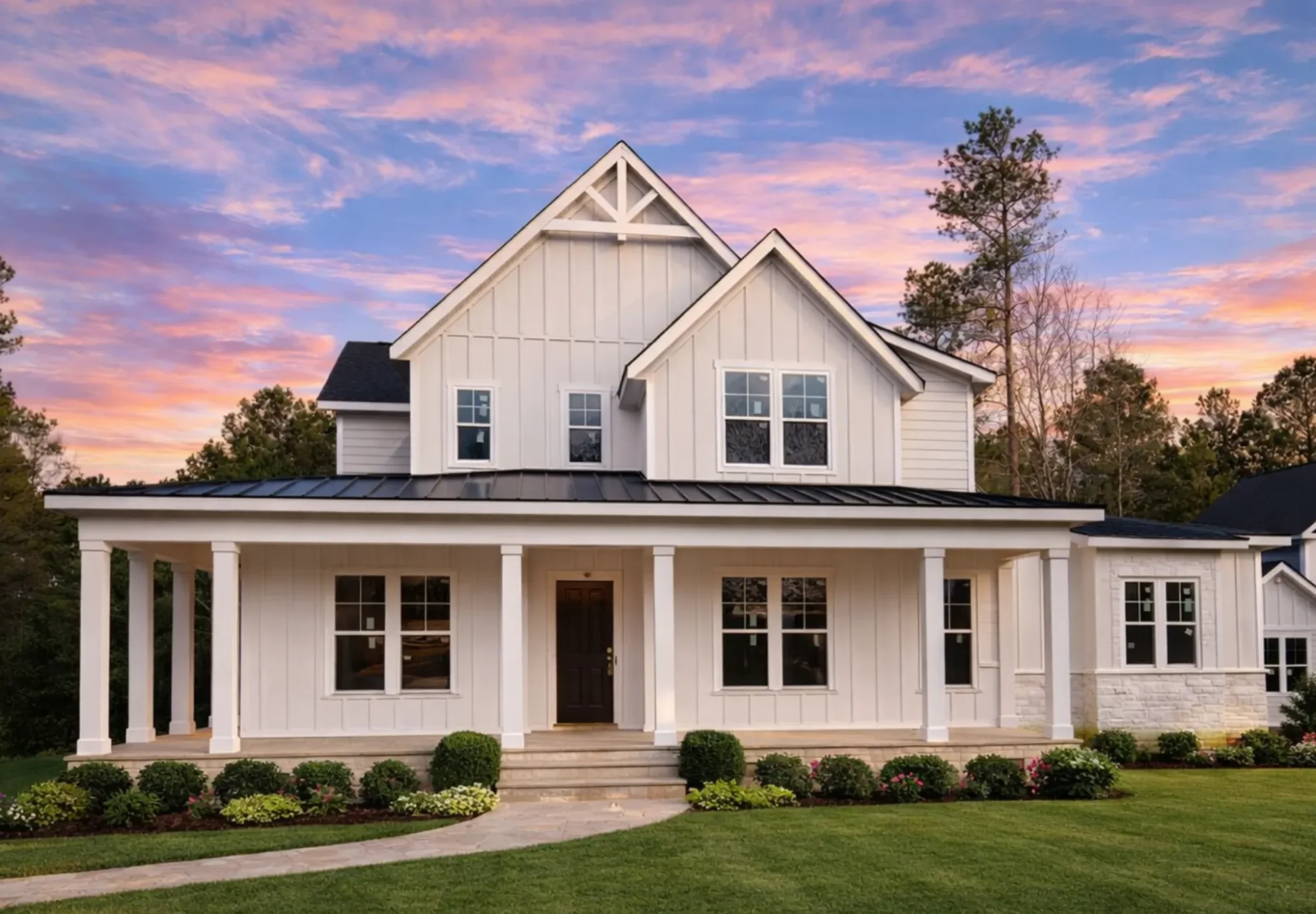 Front elevation of a Modern Farmhouse style home featuring board and batten siding, stone veneer accents, black windows, and a covered front porch
