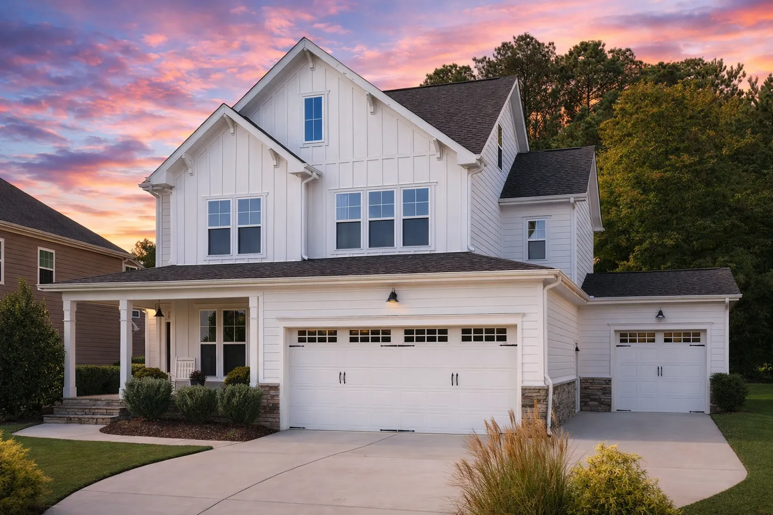 Front elevation of a New American modern traditional house with board and batten siding, gabled rooflines, and covered front porch