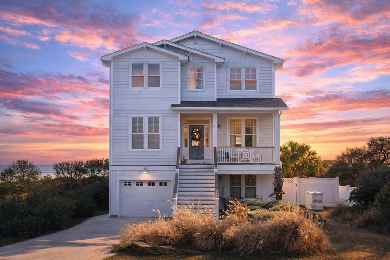 Front elevation of a Coastal Traditional shingle-style home with Charleston balcony, elevated entry, and classic coastal proportions