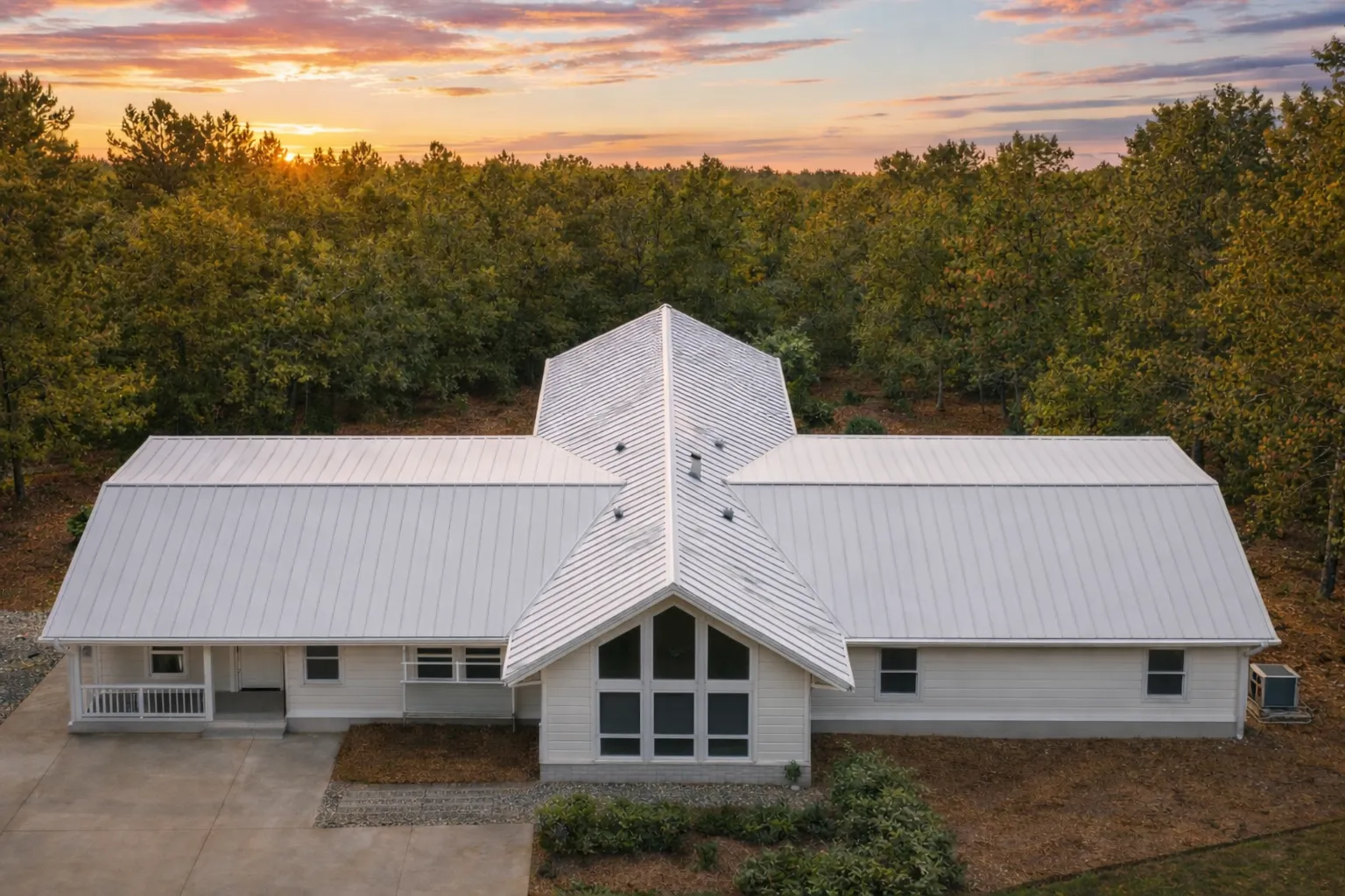 Front view of a Rustic Farmhouse Ranch style home with stone and horizontal siding, timber gable entry, and expansive lawn