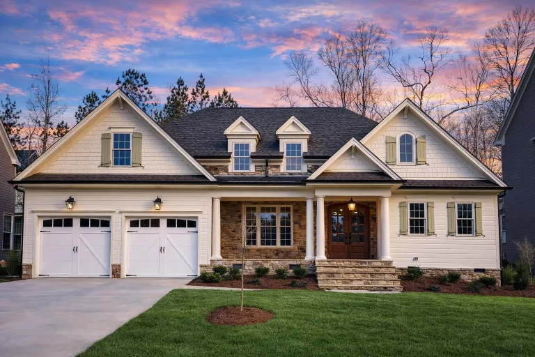 House Plans with Spacious Laundry Room 25 Front exterior view of a New American Traditional style house with horizontal siding, stone accents, gabled rooflines, and a welcoming covered porch