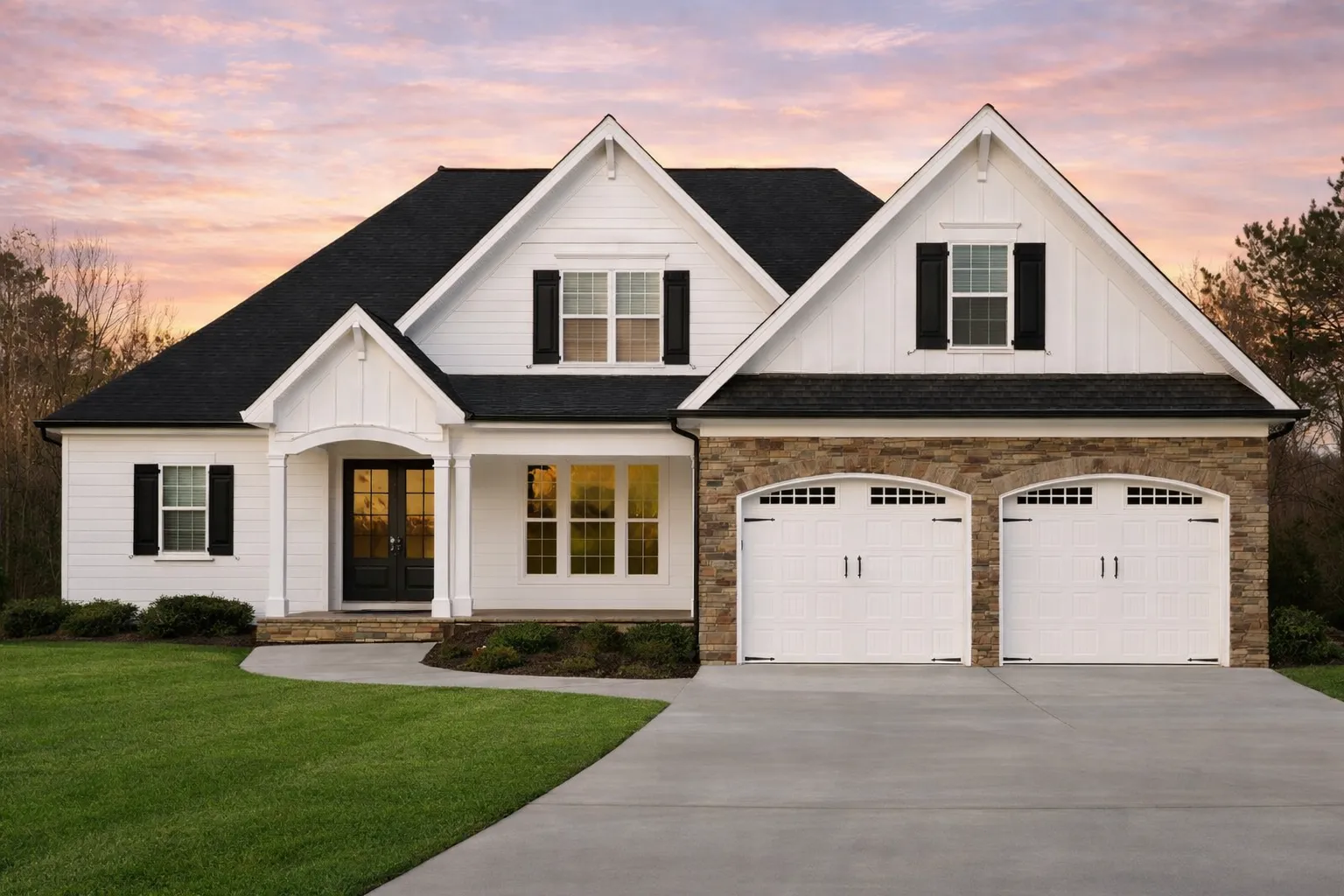 Front exterior of a Traditional New American style home with horizontal siding, brick accents, symmetrical gables, and attached two-car garage