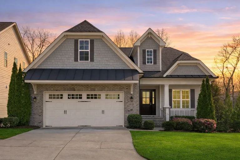 Front elevation of a Modern Farmhouse New American style home featuring horizontal siding, stone accents, black shutters, and a welcoming covered entry
