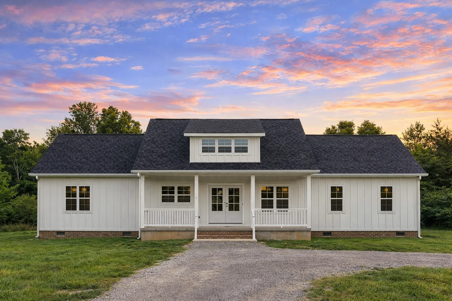 Front exterior view of a Traditional Ranch style Southern Farmhouse featuring horizontal siding, brick foundation, and a welcoming covered front porch.