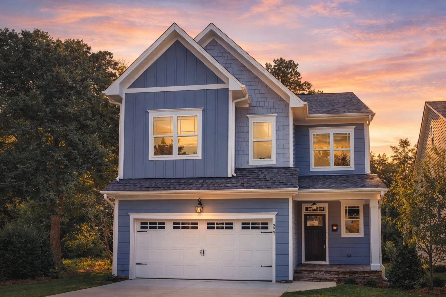Front elevation of a modern farmhouse style two-story home with white lap siding, black shutters, brick accents, and a covered entry