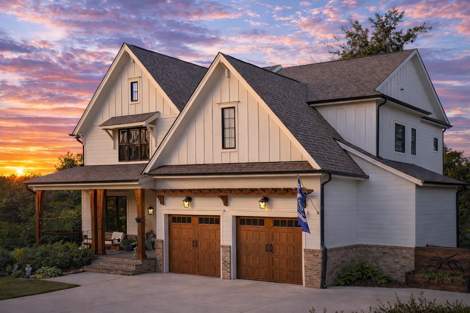 Front exterior of a Modern Farmhouse style home featuring board and batten siding, brick foundation accents, steep gabled rooflines, and a welcoming covered porch