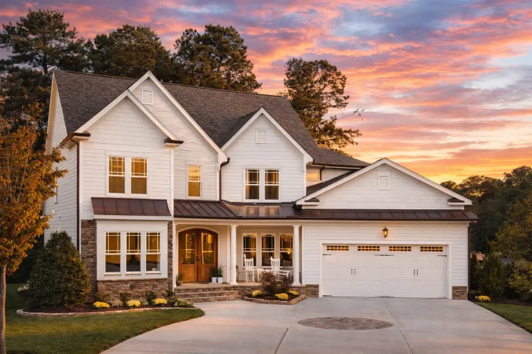 Front elevation of a Modern Farmhouse with board-and-batten siding, lap siding, stone accents, and symmetrical traditional detailing